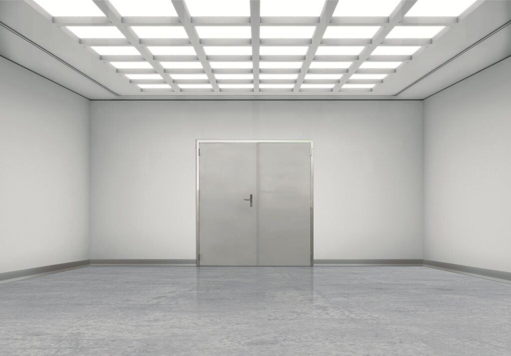 Sterile room with grid ceiling lights and metal double doors