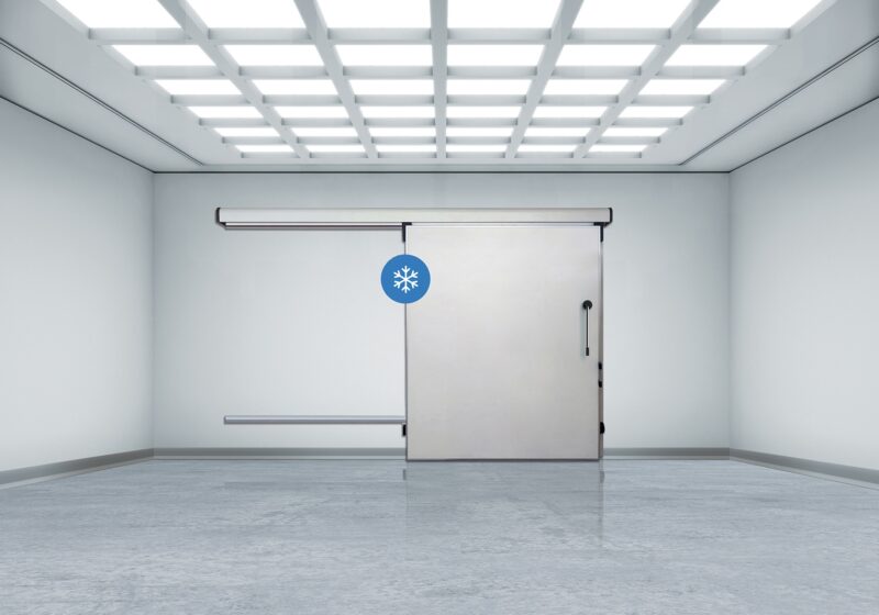 Bright industrial room with sliding cold storage door and snowflake icon